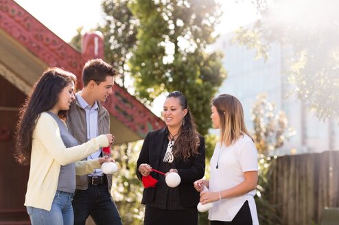 Students gather outside a marae.